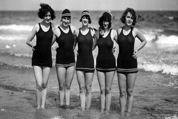 A group of young women pose at Miami Beach circa 1925. The one-piece women's bathing suits popular in the decade helped pave the way for modern swimwear.
