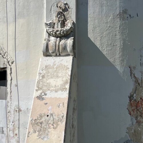 A crumbling decorative feature at the base of the Sulphur Springs Water Tower.