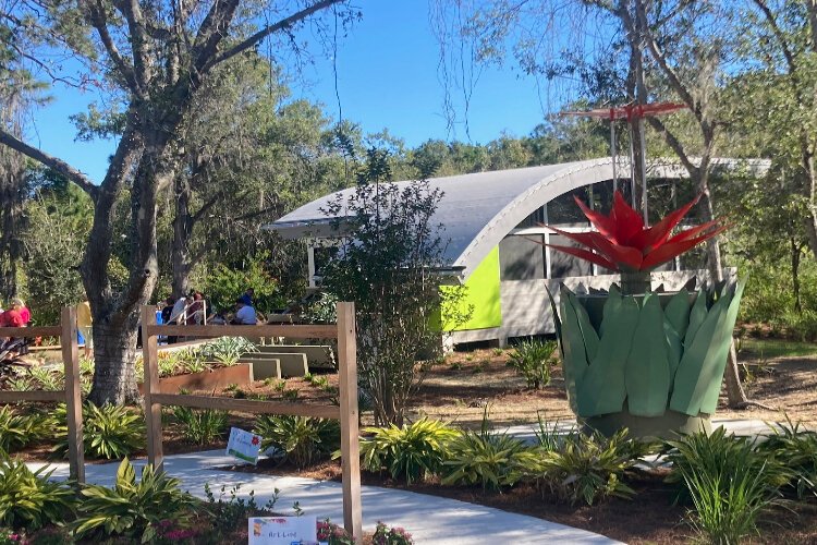 A rain harvesting sculpture by artist Allison Newsome and the outdoor classroom  at the Florida Botanical Gardens' Majeed Discovery Garden.