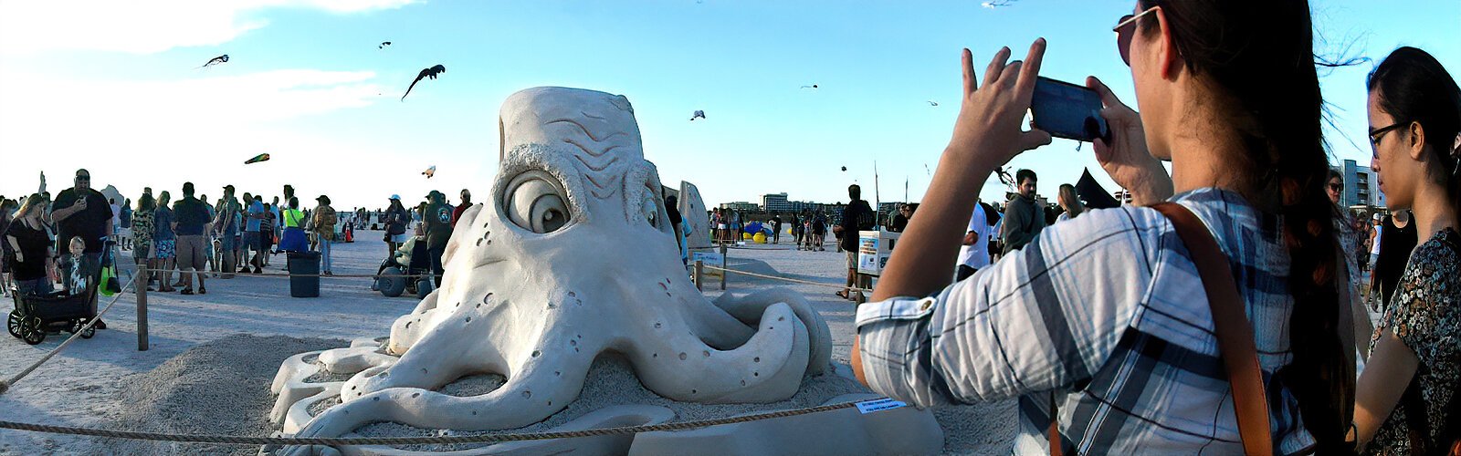 The whimsical “Clocktopus” by local sculptor, artist and street painter Damon Meri of Seminole FL gets its portrait taken by Sanding Ovations spectators.