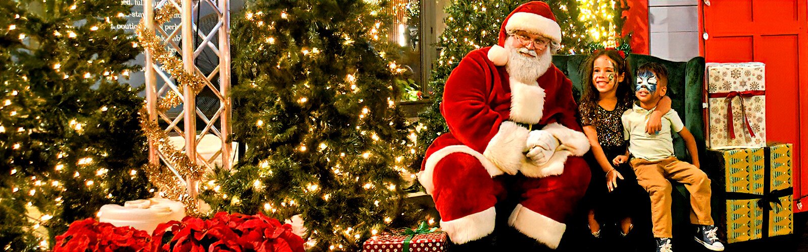 Lucia, 6, and Mikhail, 3, pose for a memorable picture with Santa during the Season Spectacular fat Water Street Tampa. 