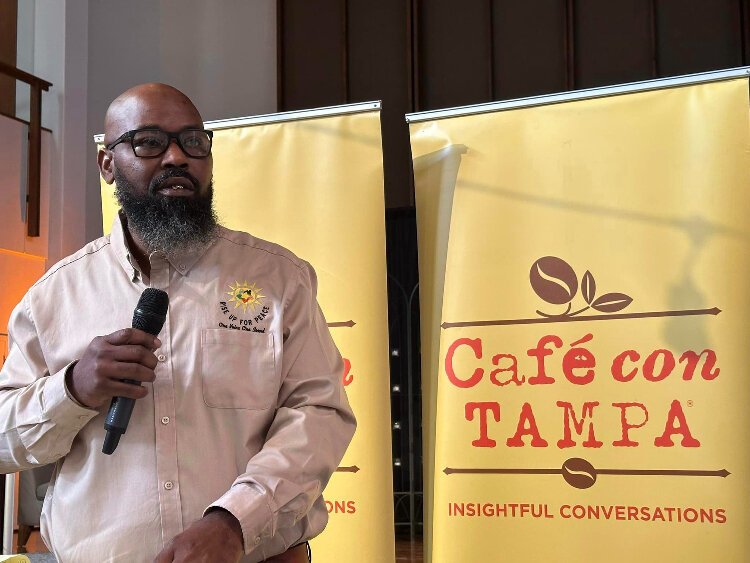 Johnny Johnson, co-founder and vice president of Rise Up for Peace, speaks about the impact gun violence has on victims' families during a Cafe con Tampa event.