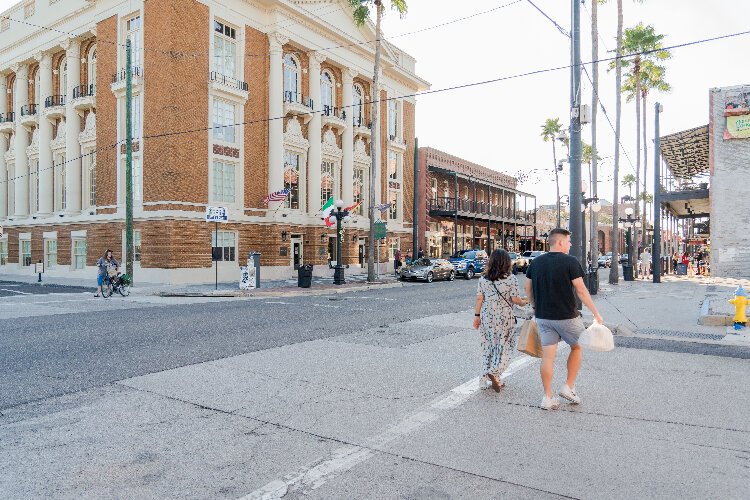 Shoppers stroll down East Seventh Avenue past the Italian Club of Tampa.
