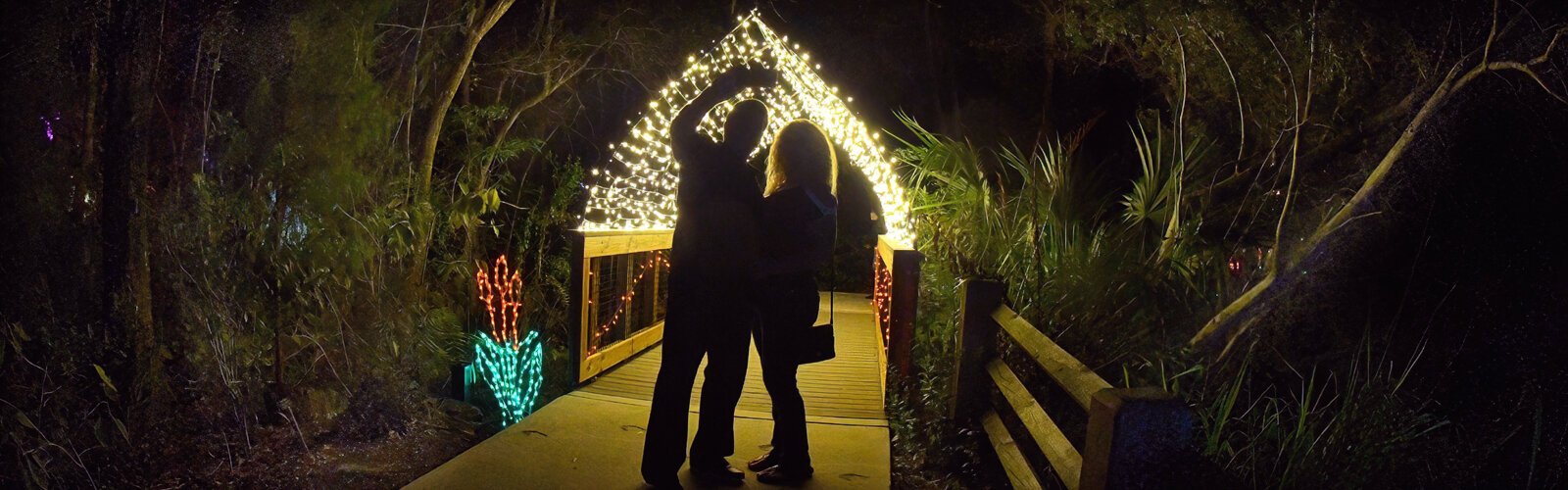 A couple takes a selfie to remember a magical evening at the traditional Holiday Lights in the Gardens event. 
