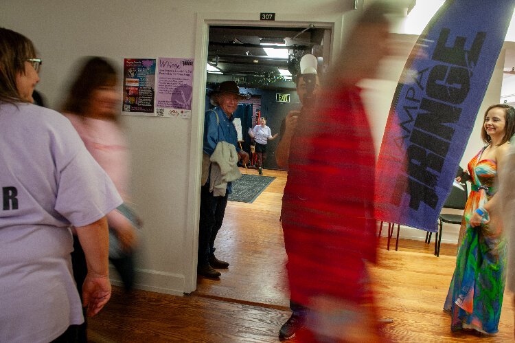 Attendees rush from one performance to another during the Whinge! Festival in the historic Ybor Kress Building. Presented by Tampa Fringe, the event requires performers to try out acts for the first time.