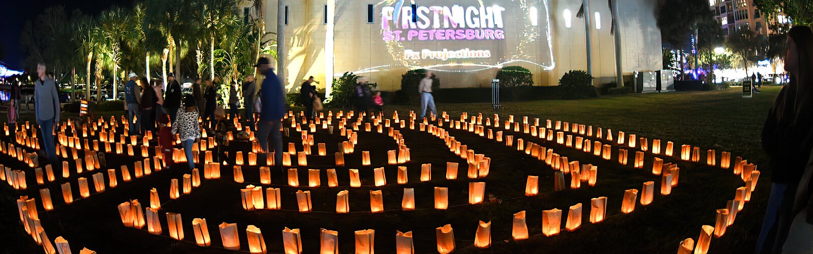 Visitors go through the Walking Labyrinth lit by hundreds of luminaria candles in brown paper bags during the First Night St Petersburg event at the North Straub Park in St Petersburg on December 31st .