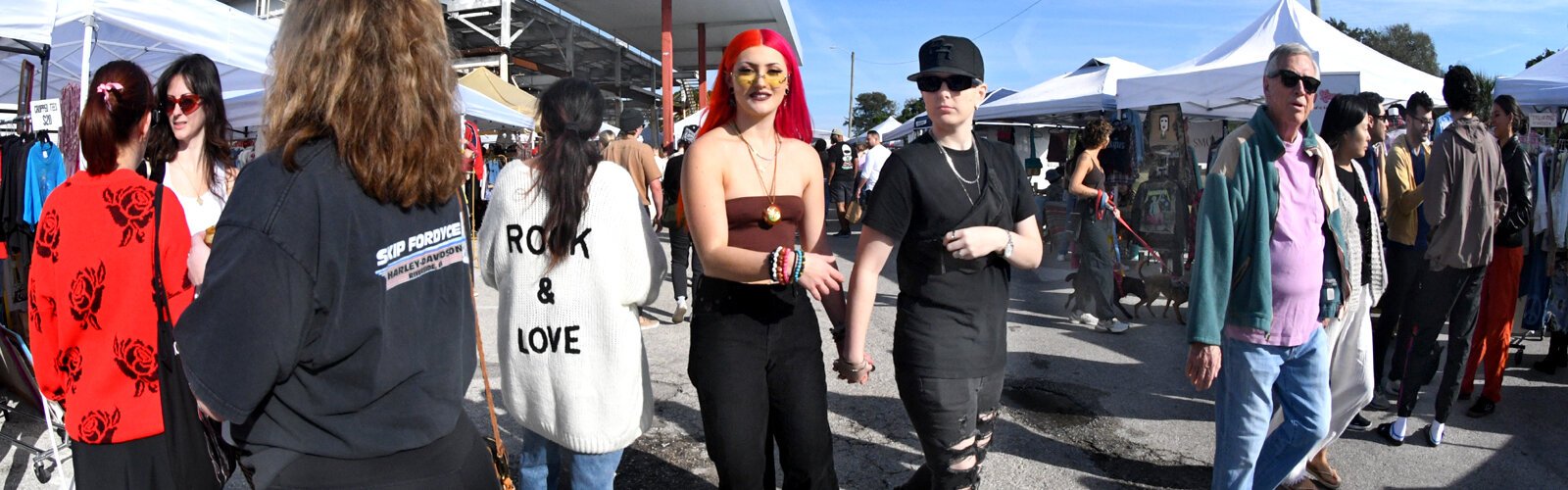 A diverse crowd wanders through the Indie Flea market in St Petersburg, enjoying the eclectic and nostalgic vibes while maybe looking for that special something.