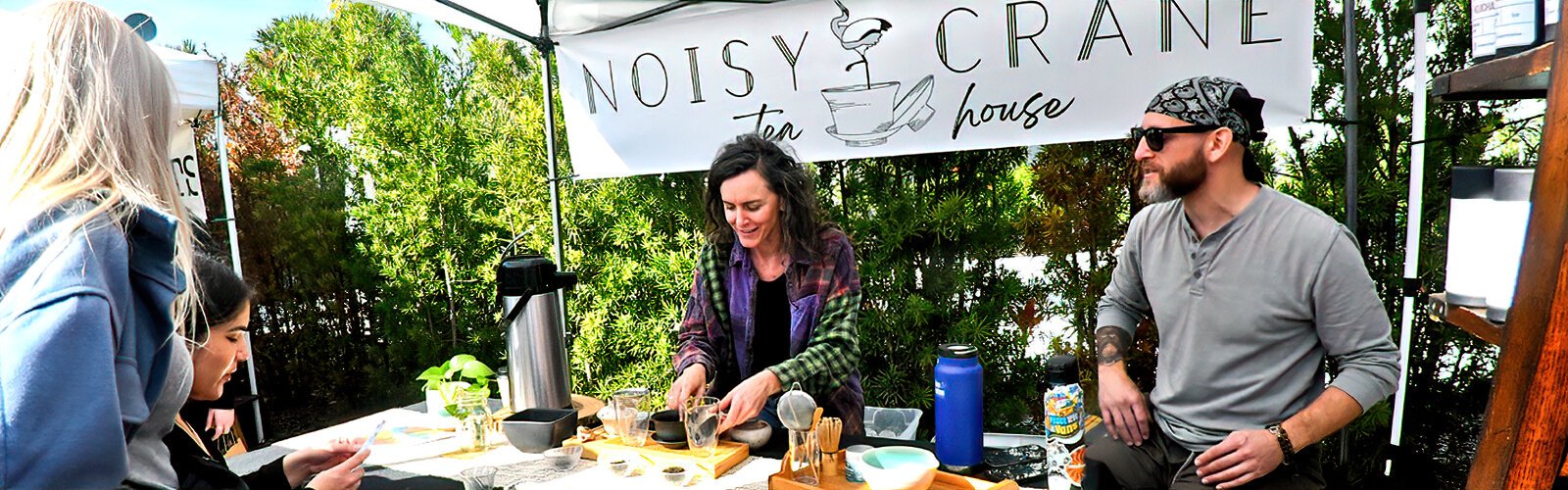 At the Noisy Crane Tea House Asian-style booth, certified-in-tea-ceremony-practice KC Cavanaugh offers patrons a gong fu cha (Chinese tea tasting) experience while sampling teas.