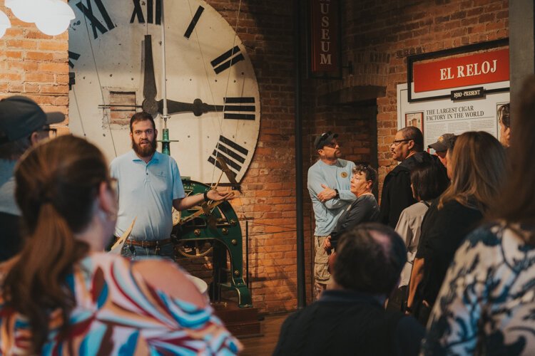 A tour group gathers on the ground floor of J.C. Newman Cigar Company's historic El Reloj factory in Ybor City. The factory sees 15,000 visitors a year.