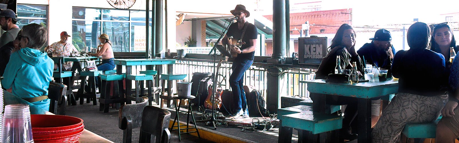  His music spilling into the street, guitarist singer Ken Apperson entertains the patrons of Centro Cantina, an outside open air bar overlooking Seventh Avenue at Centro Ybor plaza. 