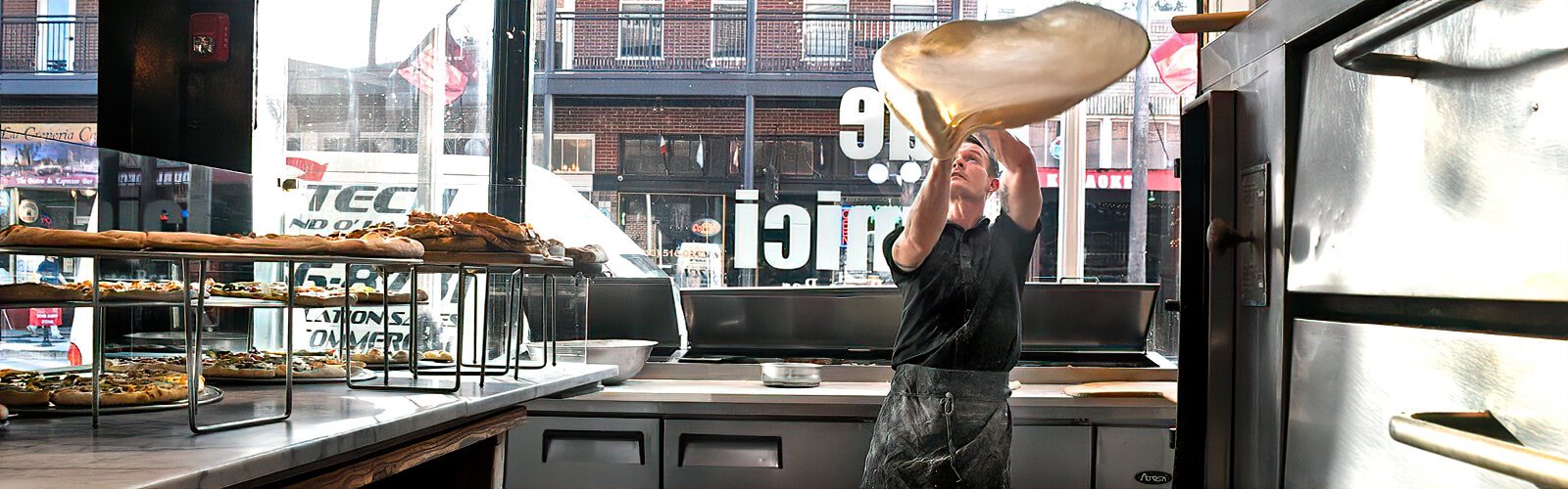 At the family-run Due Amici pizza & pasta Italian restaurant, Chris takes pride in skillfully tossing dough that will turn into one of their appetizing extra-large pizzas.