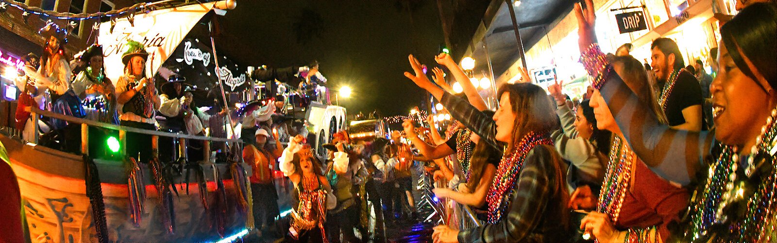 Spectators cheer the Krewe of Alegria, Tampa Bay’s first all-female Gasparilla krewe, established in 1986 and comprised of professional women from the Tampa Bay area.