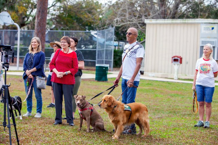 Mauricio Rosas with his dogs Nebraska and Cassian at the ribbon-cutting ceremony for Henry and Ola Dog Park.