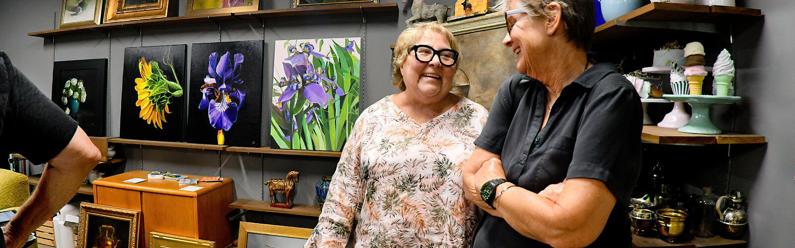 Artist Nancy Cohen exchanges friendly talk with a guest in her studio at ArtsXchange during the Second Saturday ArtWalk.