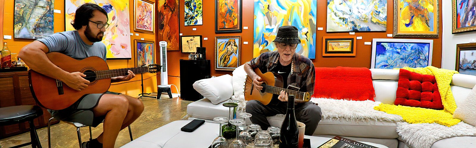 Artist Robert Sutherland starts an impromptu song on his guitar with visitor Mike Balan, who just moved to St Pete from Phoenix.