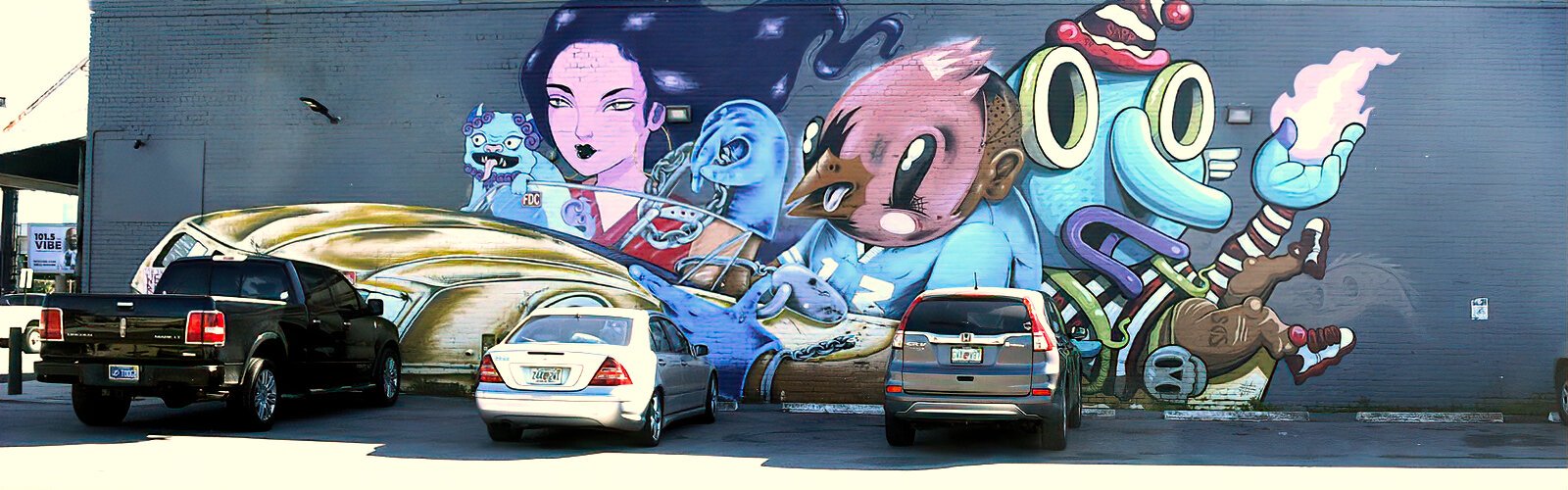 This mural of characters in a Cadillac was created by artists Lillipore, Sentrock, Jujmo and Birdcap in 2019.