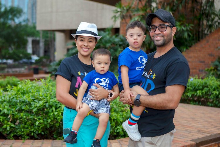 enny and Jorge Gomez hold their sons Jassiel and Jariel at the City of Tampa's event for World Down Syndrome Day.