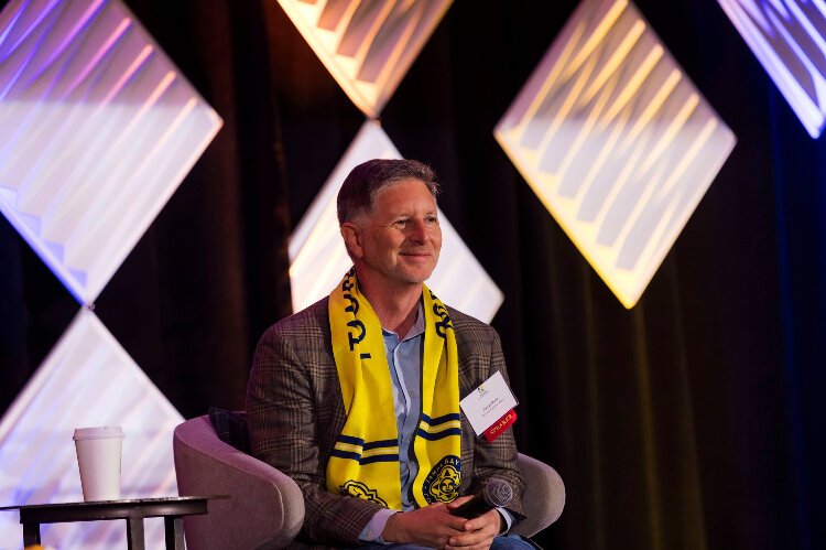 Tampa Bay Sun co-owner Darryl Shaw, with the club scarf draped over his shoulders, at the Tampa Downtown Partnership's annual State of Tampa's Downtown Forum.