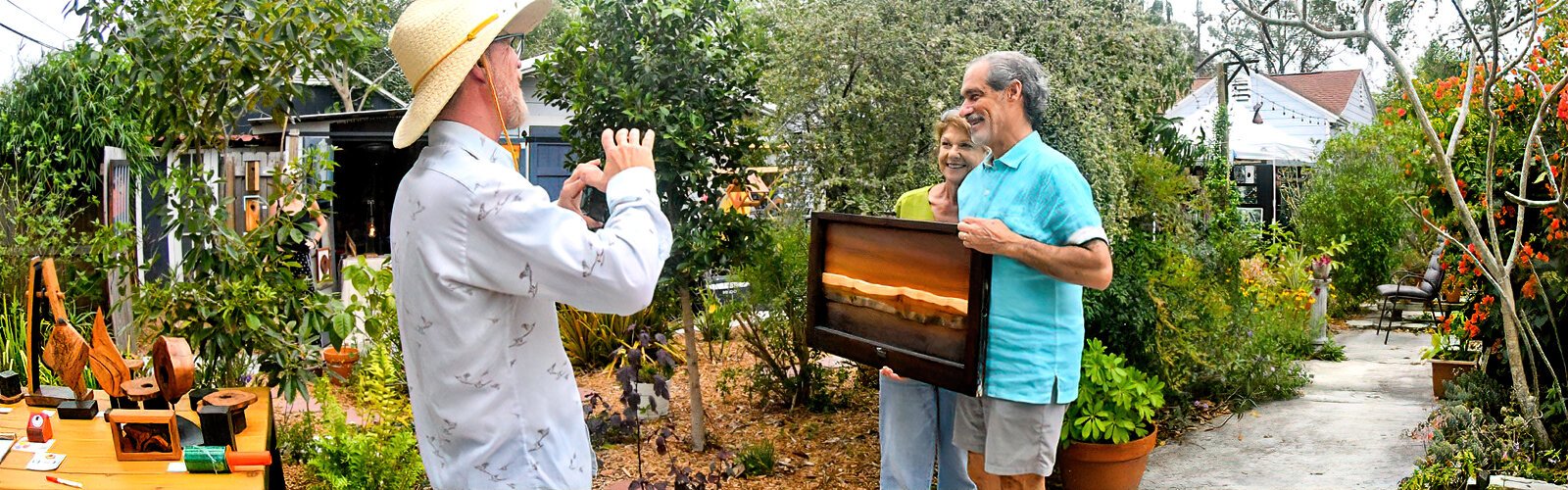 Wood craftsman Scott Solary takes a photo of the artwork he just sold to a happy couple during the 8th annual Historic Kenwood Tour of the Arts.