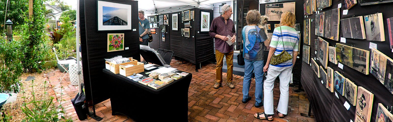 Visitors stroll through the art space of photographer and mixed-media artist Luci Westphal, where they can purchase art directly from the artist.