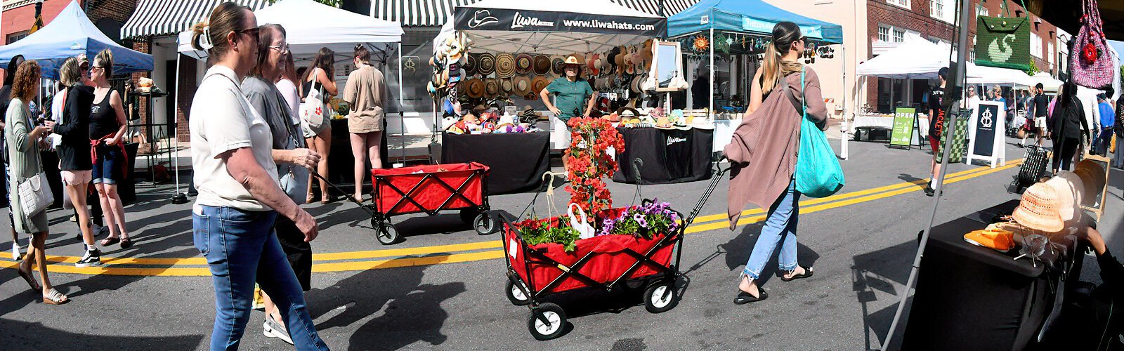 A Lakeland Downtown Farmers Curb Market shopper walks along Kentucky Avenue with her floral acquisitions.