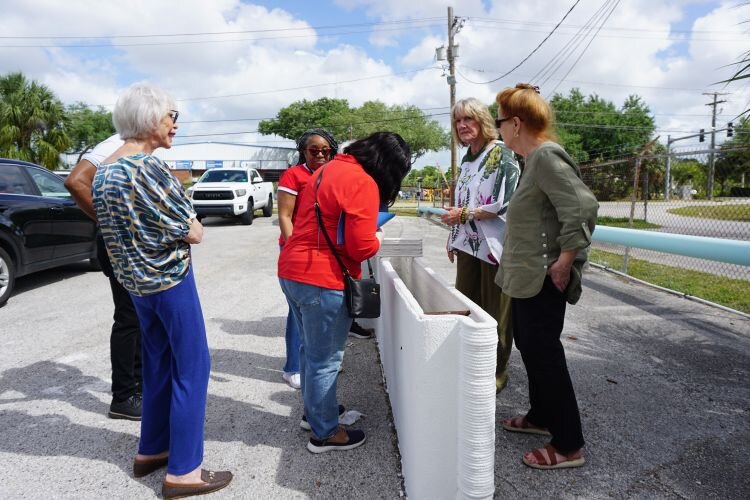 CDC of Tampa Vice President Real Estate Development Vanessa B. McCleary leads members of the Athena Society on a community impact tour.