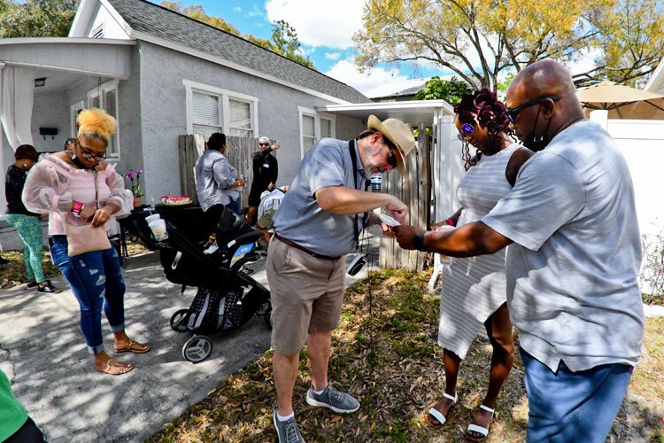 Historian Rodney Kite-Powell uses a map to show descendants Harold Doby Jr. and his daughter Jasmine the location of another Doby family house that no longer exists.