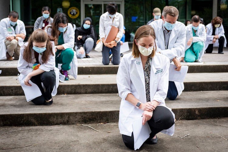 The #whitecoatsforblacklives participants gathered outside the Morsani Center on the USF Tampa campus and at 17 Davis near downtown as part of nationwide reflection on institutional racism.