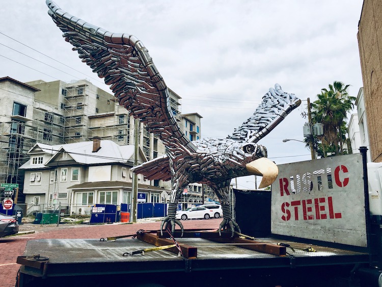 An eagle sculpture by Rustic Steel being tested for wind resistance on the back of a flatbed truck.