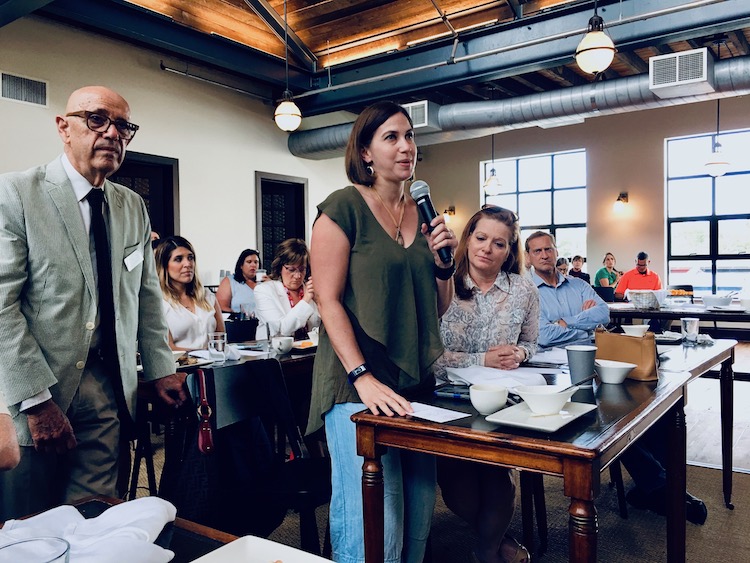 Vanessa Rukholm of Sidewalk Stompers poses a question at Cafe con Tampa discussion.