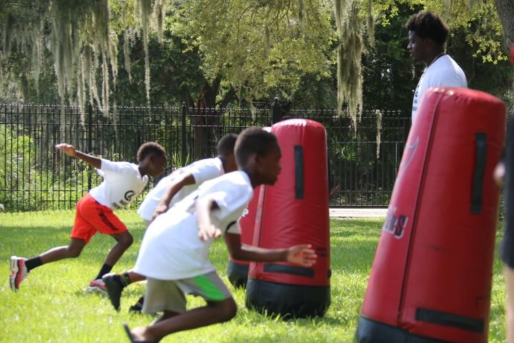 The University Area CDC's inaugural Get Moving! youth football camp in July 2024 featured Tampa Bay Bucs players Calijah Kancey, Tykee Smith, and Rachaad White