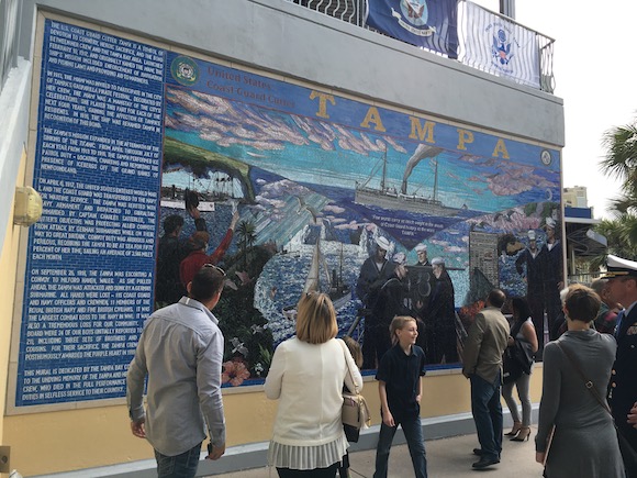 A crowd of visitors explores mural details at Tampa Bay History Center.